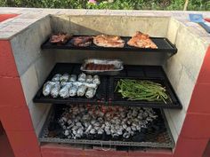 an outdoor bbq grill with various foods on it