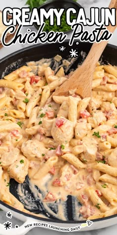 creamy cajun chicken pasta in a skillet with a wooden spoon