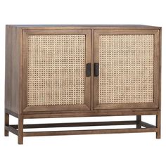 the sideboard is made from wood and has two doors, one with rattan panels