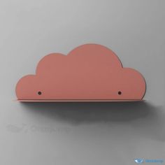 a pink cloud shaped shelf on a gray wall