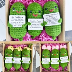 three crocheted pickles are in a box