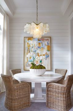 a white table with four chairs around it