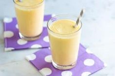 two glasses filled with smoothie sitting on top of a purple and white polka dot napkin