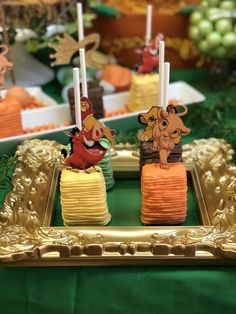 the lion king cake pops are decorated with candles