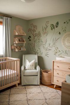 a baby's room with a chair, crib and dresser