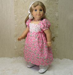 a doll wearing a pink dress and white shoes