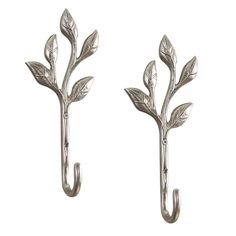 two metal hooks with leaves on them