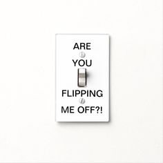 a white light switch with the words are you flipping me off?