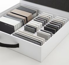 an open white box filled with lots of different types of cards and folders on top of each other