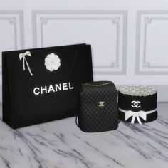 three black bags and one white bag on a marble counter top with chanel logos