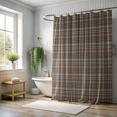 a bathroom with a bathtub, sink and shower curtain that has plaid print on it