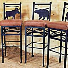 three chairs with animals on them in front of a wall