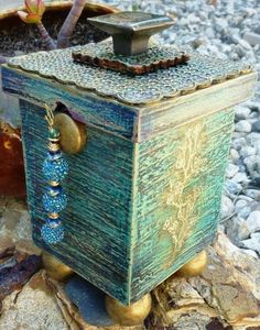 an old wooden box sitting on some rocks