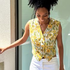 A fresh c.1990s vintage waistcoat by Salvatore Ferragamo, in summery yellow and green floral print fine wool.  V neck, with gold tone buttons, cropped to the waist. Material:  wool Size: EU42 UK10 Measurements (laid flat): Shoulder to shoulder:  36cm Bust: 92cm Length: 50cm Condition: excellent Retro V-neck Vest For Spring, Yellow V-neck Vest For Summer, Vintage V-neck Vest For Spring, Fitted Summer Vest With Buttons, Cropped Summer Vest With Buttons, Summer Cropped Vest With Buttons, Cropped Vest With Button Closure For Summer, Vintage Fitted Vest For Summer, Retro Fitted Summer Vest