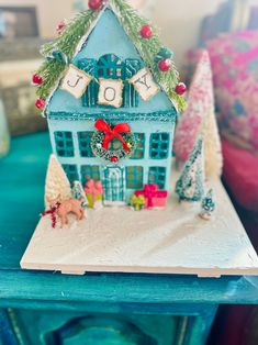 a small blue house decorated with christmas decorations