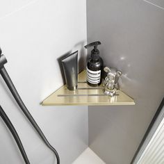 a shower shelf with soap, shampoo and lotion on it