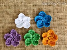 four crocheted flowers with the words pattern and instructions written below them on a piece of burlock