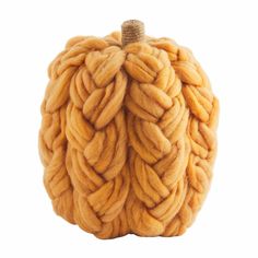 a wool pumpkin with braided ends on it's side, isolated against a white background