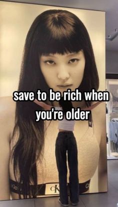 a woman standing in front of a poster with the words save to be rich when you're older