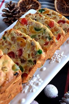 slices of bread sitting on top of a white plate next to eggs and pine cones