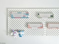 a peg board with two stuffed animals next to it