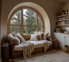 a living room filled with furniture and a large round window covered in windowsills