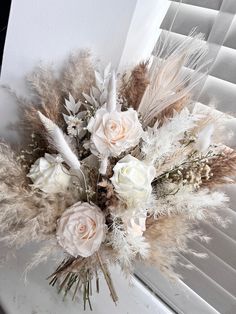 a bouquet of flowers sitting on top of a window sill