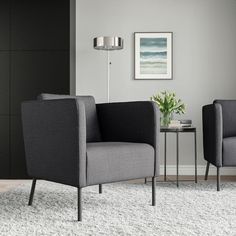 two gray chairs sitting next to each other on top of a white carpeted floor