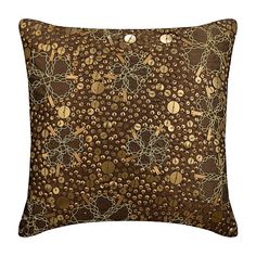 a brown pillow with circles and chains on it