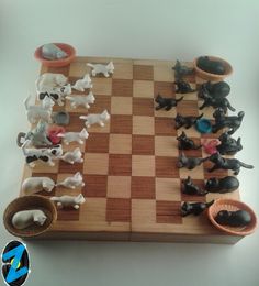 the chess board is made out of wood and has black and white pieces on it