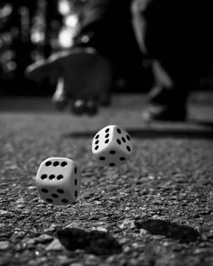 two dices laying on the ground in front of a person