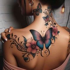 a woman with a butterfly tattoo on her back