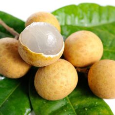 some nuts and leaves on a white surface