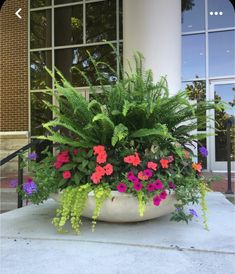 a planter filled with lots of colorful flowers