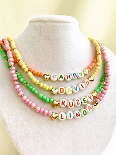 "Welcome to our vibrant and joyful personalized name necklace collection! Our colorful necklaces are perfect for children and make for a wonderful kids' birthday gift, designed to bring smiles to their faces. With six stunning color options to choose from, each necklace is a unique masterpiece. Crafted with colorful beads and adorned with Mother of Pearl letters that spell out a custom name, these necklaces are truly one of a kind. Make your little one's day special by gifting them a personalized name necklace that reflects their unique personality and style. Whether it's for a birthday, a special occasion, or just to show your love, these necklaces are sure to be cherished keepsakes.\" HOW TO ORDER ? 1- Choose the letter quantity of the name/word/phrase/initials you want. 2- Find the righ Trendy Personalized Necklaces For Personalized Gifts, Trendy Personalized Necklaces For Gifts, Trendy Personalized Necklace For Personalized Gift, Cute Personalized Multicolor Charm Necklaces, Trendy Personalized Charm Necklace For Mother's Day, Trendy Personalized Adjustable Charm Necklaces, Trendy Adjustable Personalized Charm Necklaces, Customized Cute Multicolor Jewelry, Customized Multicolor Cute Jewelry