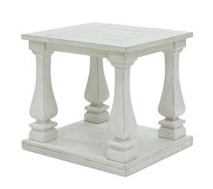 a small white table with pillars on top