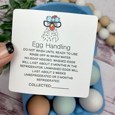 a person holding up an egg handling card