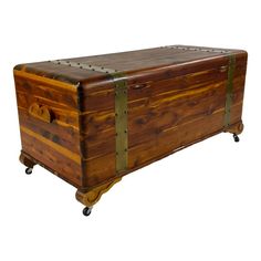 an old wooden trunk sitting on wheels