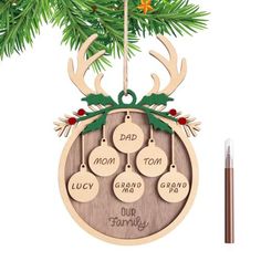 a christmas ornament hanging from a tree with the words dad, mom, and two