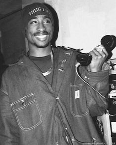 a black and white photo of a man holding a hair dryer