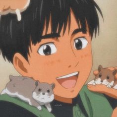 a boy holding two hamsters in his arms