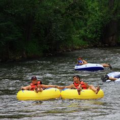 several people on rafts floating down a river