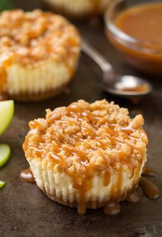 an apple pie with caramel sauce drizzled on top and apples in the background