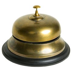 an old brass plate with a black base