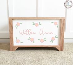 a wooden sign with pink flowers and the words willow avenue written in cursive writing