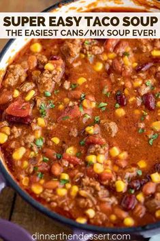 a pot filled with chili and corn on top of a wooden table