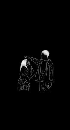 two people standing next to each other on a black background with one pointing at another