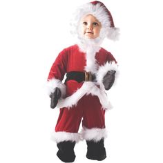 a little boy dressed in a santa suit