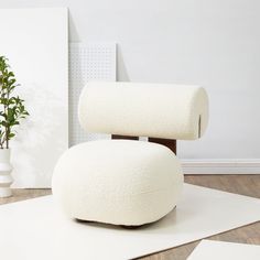 two rolls of toilet paper sitting on top of each other in front of a potted plant