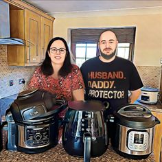 a man and woman are standing in the kitchen next to crock pot's